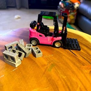 Pink fork lift with cinder block set